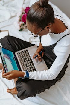 African woman working on laptop indoors in Abuja, Nigeria. Modern remote work scene.